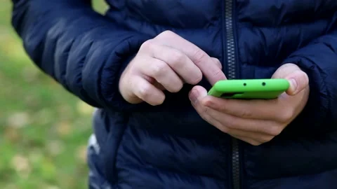 Close-up of the hand of a young guy holding a smartphone. Stock Footage 141462038