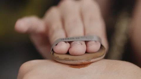 Close-up of hand of a young man applying shadows with a soft sponge for a drag Stock Footage 272604291