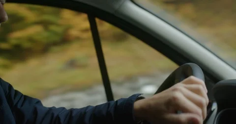 Close-up of Hand of Young Man While Driving His Car Stock Footage 127195066