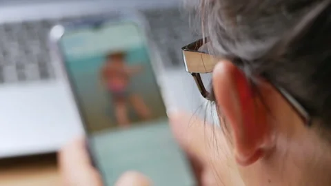 Close up hand of young woman using smart phone in the living room at home. Stock Footage 150418507