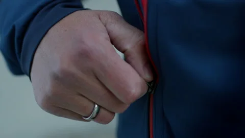 Close-Up of Hand Zipping Up a Jacket Stock Footage 300272927