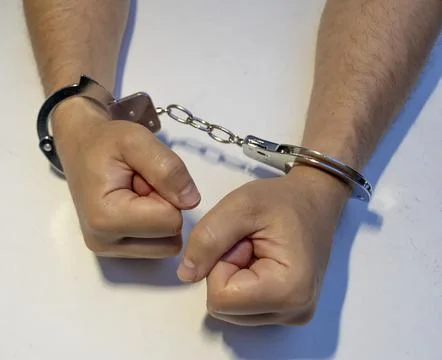 Close-up of handcuffed hands, arrest Stock Photos