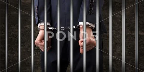 Close handcuffed man in jail Stock Photos
