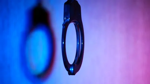 Close-up of handcuffs in strobing blue and red light Stock-Footage 167253515