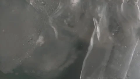 Close up handheld focus pull bubbles on ice cubes in clear drink Prores 422 log Stock Footage 213285760