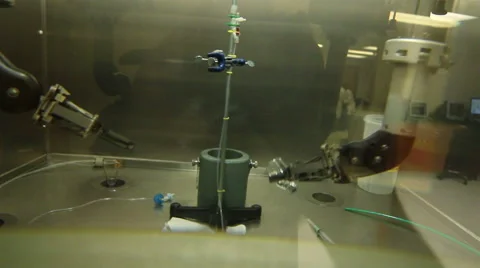 CLOSE UP-HANDHELD. Laboratory worker use mechanical arms to make a syringe shot. Stock Footage 42766942