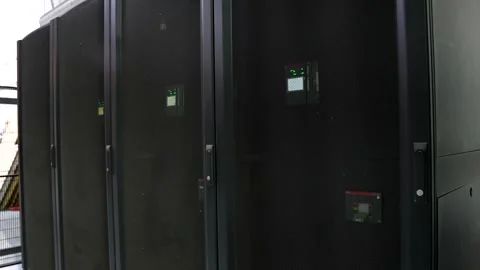 Close Up Handheld Pan Across Black Server Cabinets with Active Lights in Da.. Video stock 341699958