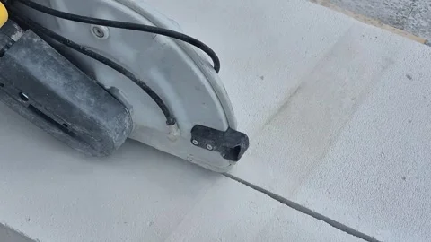 Close up of handheld power cutter cutting concrete wall Stock Footage 340276162