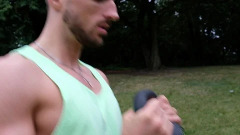 Close-up handheld shot of active young man doing strength exercise 스톡 동영상 120431849