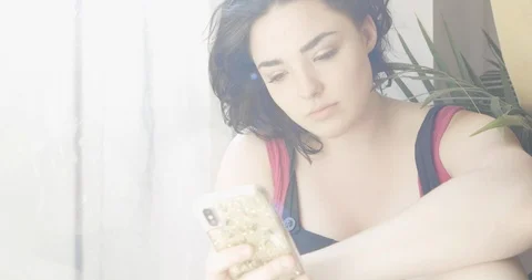 Close-up handheld shot of attractive young women using a smartphone Stock Footage 114868972