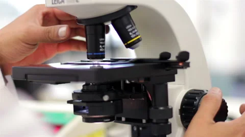 CLOSE UP-HANDHELD SHOT. Blood test tubes being analyzed by a laboratory worker. Stock Footage 42829905