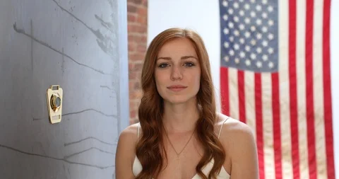 Close-up handheld shot of confident redhead young woman smiling at camera Stock Footage 119793363