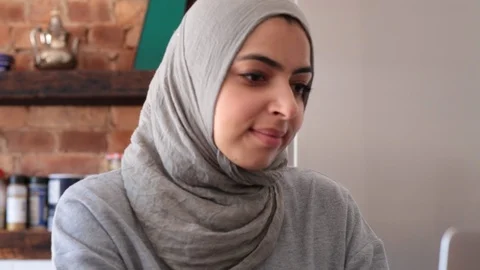 Close-up handheld shot of confident young female freelancer reading on laptop Stock Footage 114860099