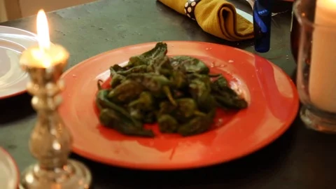 Close-up handheld shot of cooked green chillies placed on dining table 스톡 동영상 114846642