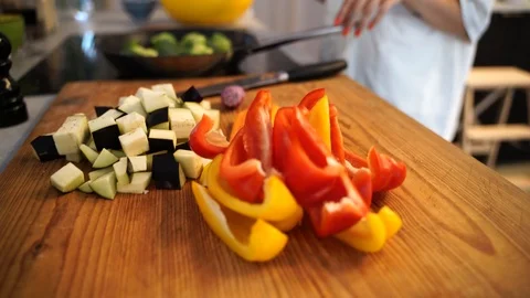 Close-up handheld shot of freshly cut vegetables on cutting board Stock Footage 114883425