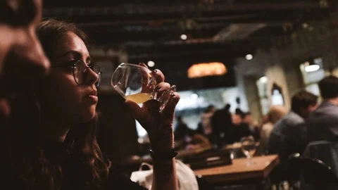 Close-up handheld shot of friends having drinks in the bar Video stock 122395694