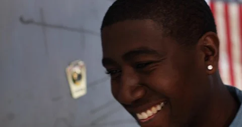 Close-up handheld shot of man standing and smiling while looking at camera Stock Footage 119751817