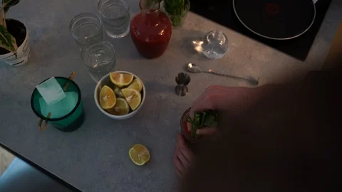 Close-up handheld shot of man stirring a drink Stock Footage 114884573