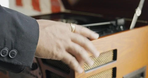 Close-up handheld shot of mans hand tapping on record player Stock Footage 120159401