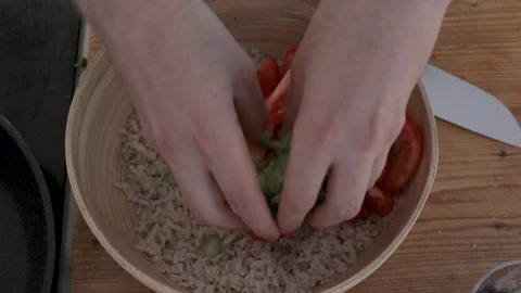 Close-up handheld shot mans hands putting scallions in bowl 스톡 동영상 114867153