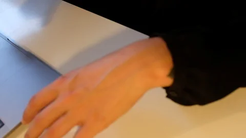 Close-up handheld shot of office workers discussing while working on laptop Stock Footage 120427960