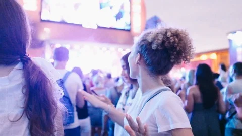 Close-up handheld shot of people dancing during event in city Stock Footage 122405221