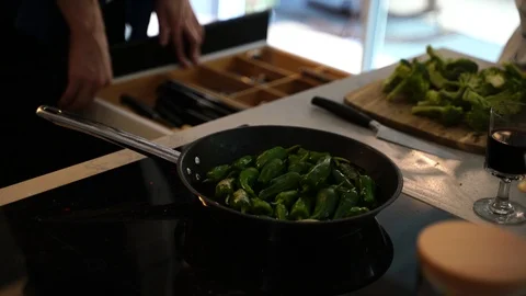 Close-up handheld shot of people preparing food in domestic kitchen Stock Footage 114883347