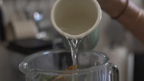 Close up handheld shot of person adding water in blender Stock Footage 122510986