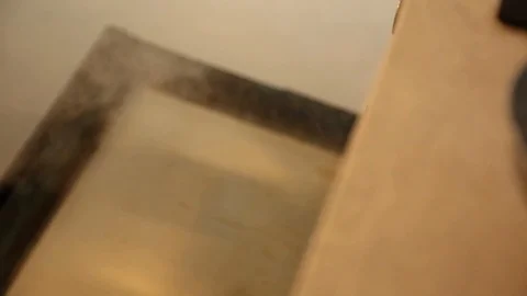 Close-up handheld shot of person removing roasted carrots from oven 스톡 동영상 114846653