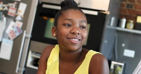 Close-up handheld shot of sibling talking while using digital tablet in kitchen Stock Footage 119795867