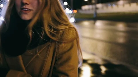 Close-up handheld shot of smiling young woman in coat standing on city street Stock Footage 122512483