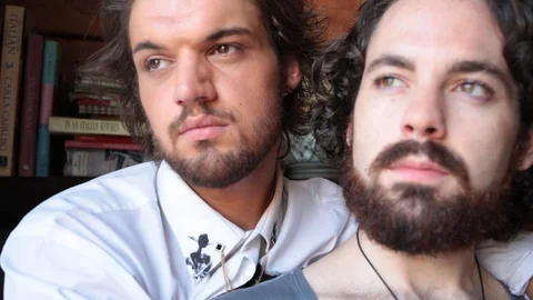 Close-up handheld shot of thoughtful romantic gay couple spending leisure time Stock Footage 114860029