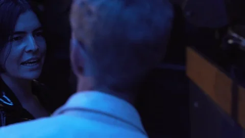 Close-up handheld shot of two young people talking and grooving in nightclub Stock Footage 114876211