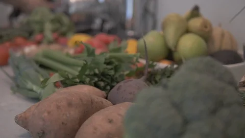Close-up handheld shot of vegetables and fruits on kitchen worktop Video stock 114841975