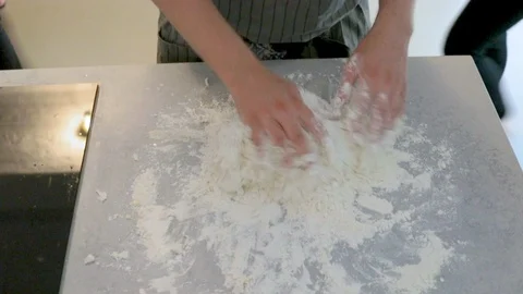 Close-up handheld shot of womans hand kneading dough on counter Video stock 114866878