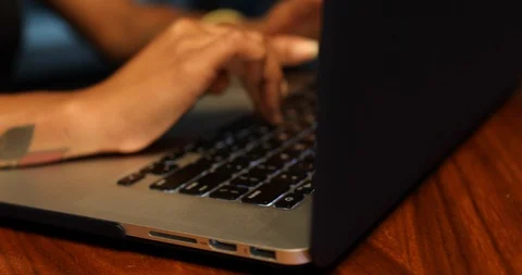 Close-up handheld shot of womans hand typing on laptop Video stock 119758048