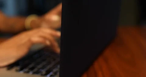Close-up handheld shot of womans hand typing on laptop Stock Footage 119771593