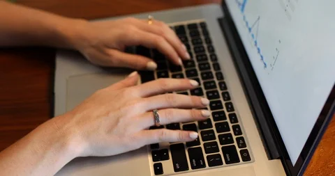 Close-up handheld shot of womans hand typing while using on laptop over table Stock Footage 119935731