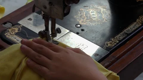 Close Up Handheld Shot of Yellow Fabric under Needle of Vintage Sewing Machine Stock Footage 346611953