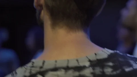Close-up handheld shot of young man dancing in nightclub Stock Footage 114876377