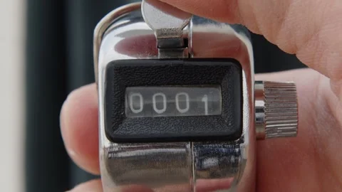 Close-Up of a Handheld Tally Counter at 0001, Manual Clicker for Tracking and Stock Footage 265090941