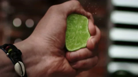Close up handheld video of hand squeezing lime Stock-Footage 131588973