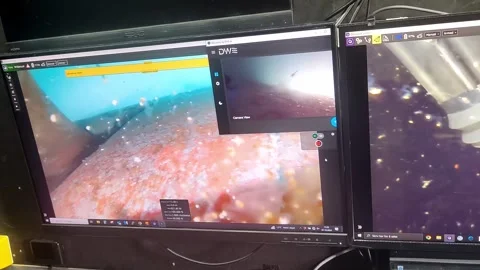 Close Handheld View of ROV Cleaning Ship Hull on Control Monitor Stock Footage 310360458