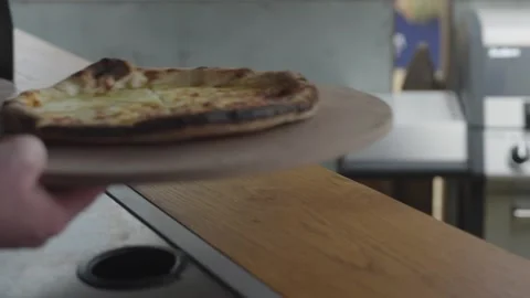 Close up handing over stone baked pizza Video stock 280121588