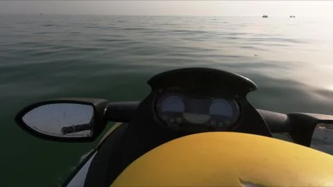 Close up of the handle bars and mirror of jet ski. Photos