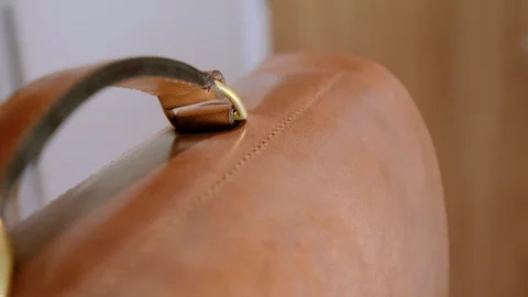 Close up of handle on beautiful hand made leather satchel Stock-Footage 96133089
