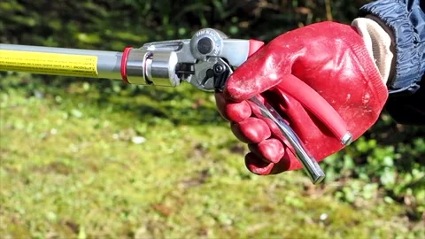Close Up Of The Handle Of A Telescopic Pruner Being Used In The Garden, UK Stock Footage 151737316