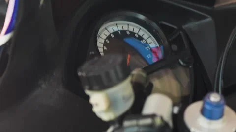 Close-up of the handlebars, hand clutch and tachometer of a sports motorbike Stock Footage 282846788
