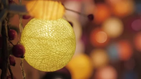 Close-up of handmade Christmas bauble from threads on background bokeh of Stock Footage 305751138