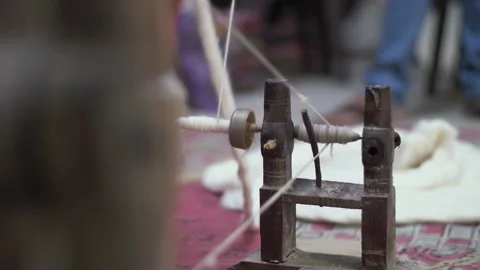 Close up of handmade cotton threads being spun on traditional spinning wheel. Stock Footage 144660504